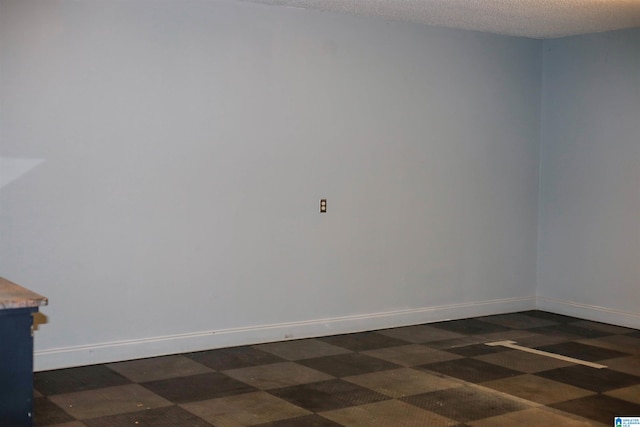 spare room with a textured ceiling