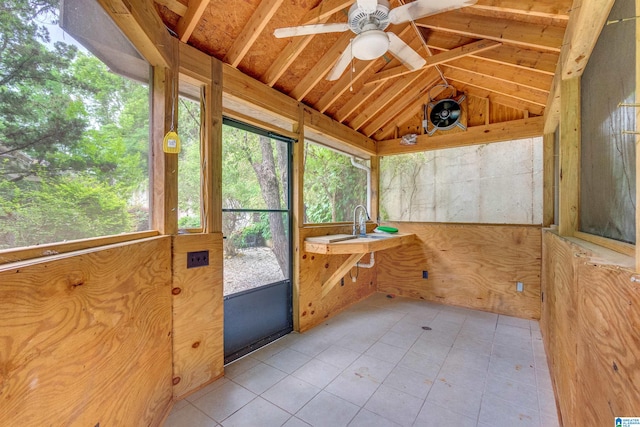 unfurnished sunroom with sink, ceiling fan, and lofted ceiling