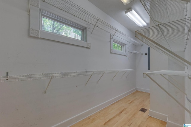 spacious closet featuring light hardwood / wood-style floors