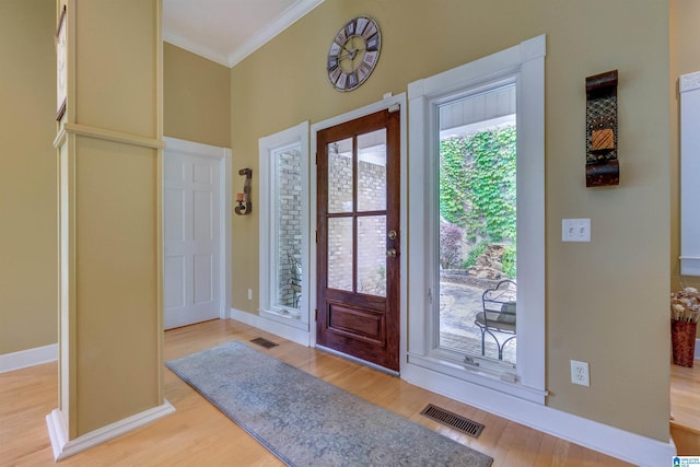 foyer featuring light hardwood / wood-style floors and ornamental molding