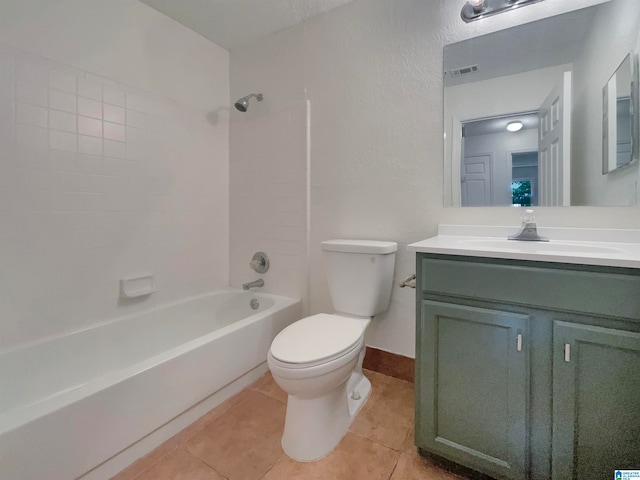 full bathroom featuring tiled shower / bath combo, tile floors, vanity, and toilet