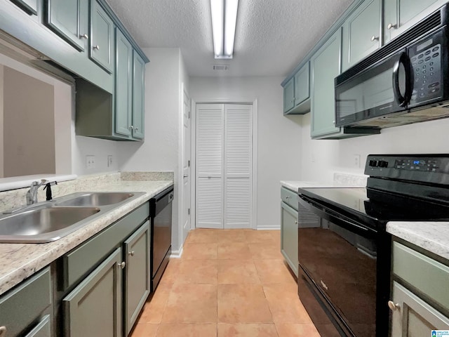 kitchen with sink, a textured ceiling, black appliances, and light tile floors