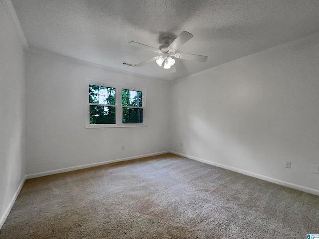 carpeted spare room with ceiling fan and a textured ceiling