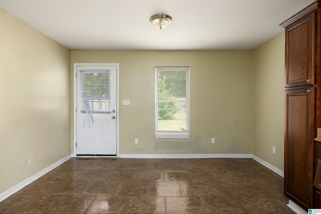 interior space featuring a healthy amount of sunlight and dark tile floors