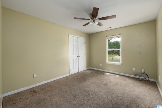 unfurnished bedroom featuring carpet flooring, a closet, and ceiling fan