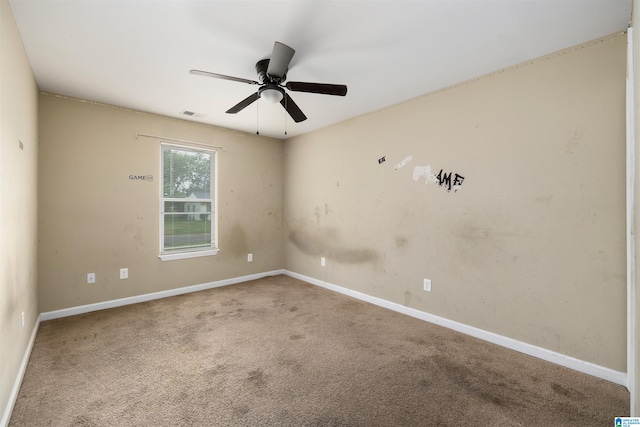 carpeted empty room featuring ceiling fan