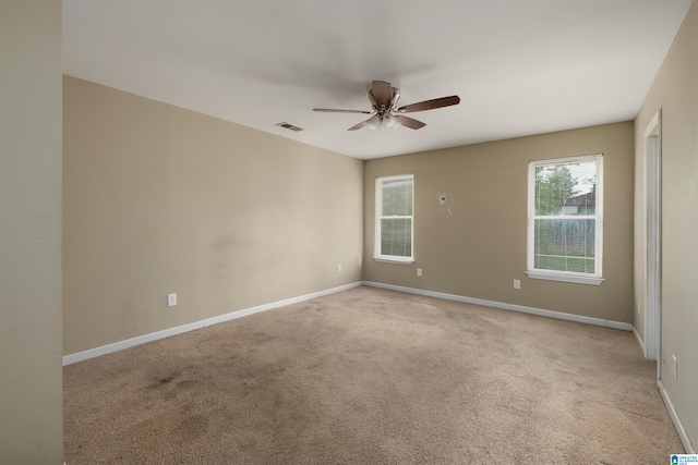 carpeted empty room featuring ceiling fan