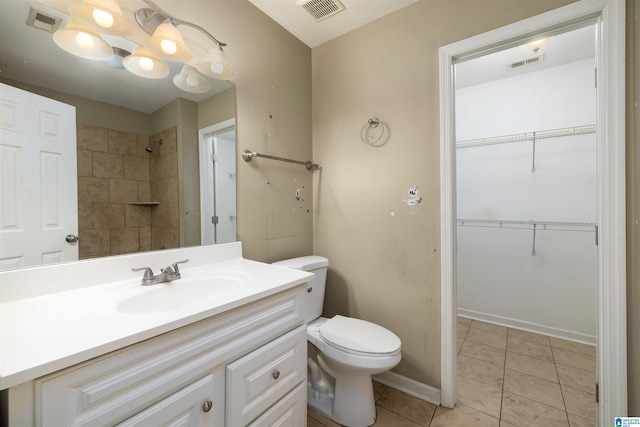 bathroom with large vanity, toilet, and tile flooring