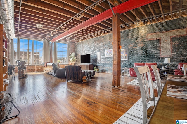 interior space with brick wall and wood-type flooring