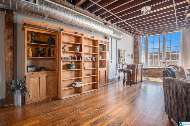 living area with built in features, french doors, and dark wood-type flooring