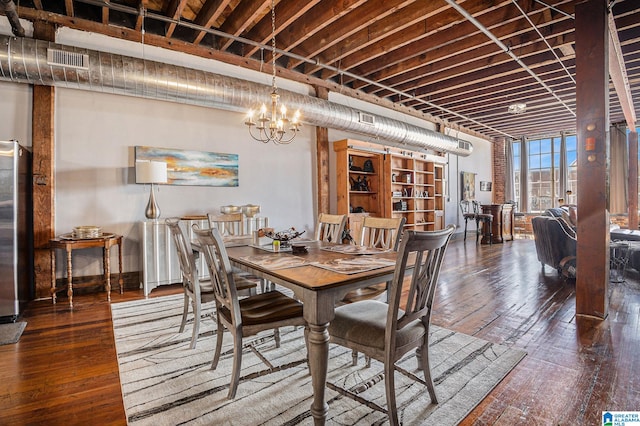 dining room featuring dark hardwood / wood-style flooring and a chandelier