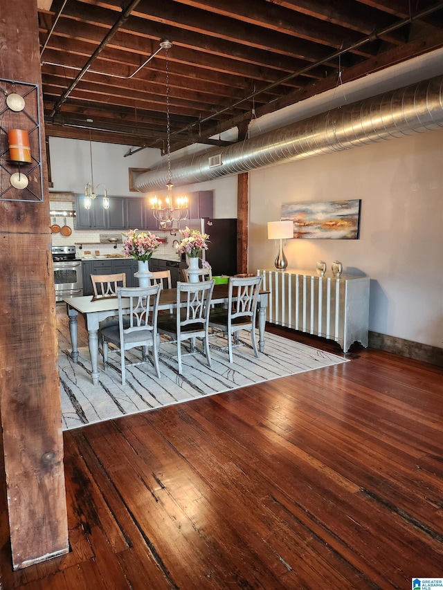 unfurnished dining area with an inviting chandelier and hardwood / wood-style floors