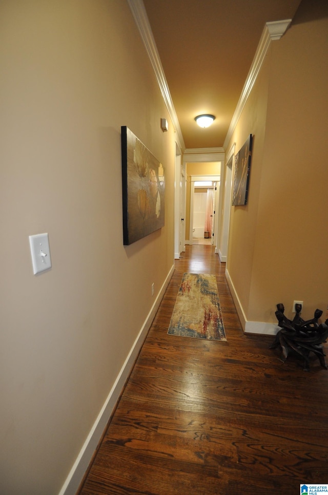 corridor featuring dark wood-type flooring and ornamental molding