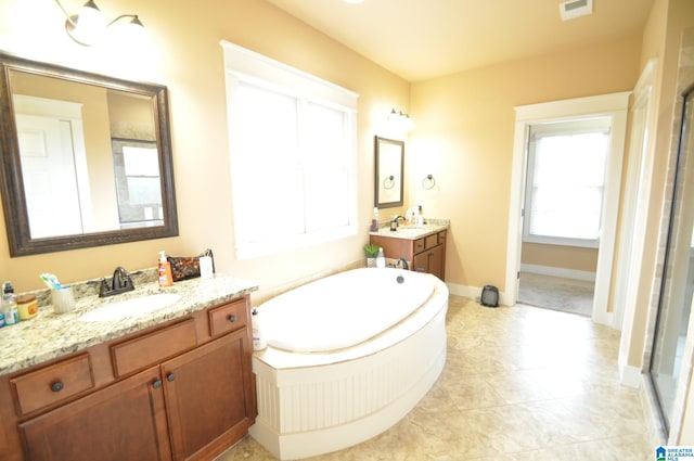 bathroom featuring tile flooring, dual vanity, and a bath