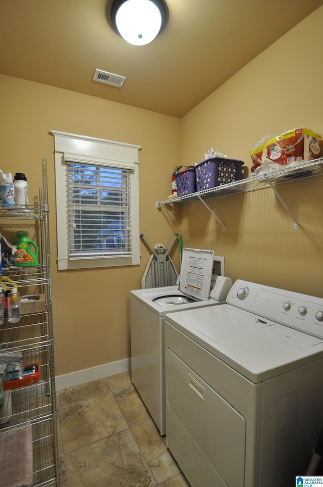 clothes washing area featuring washer and dryer, tile floors, and washer hookup