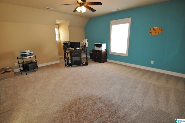 interior space with vaulted ceiling, ceiling fan, and carpet