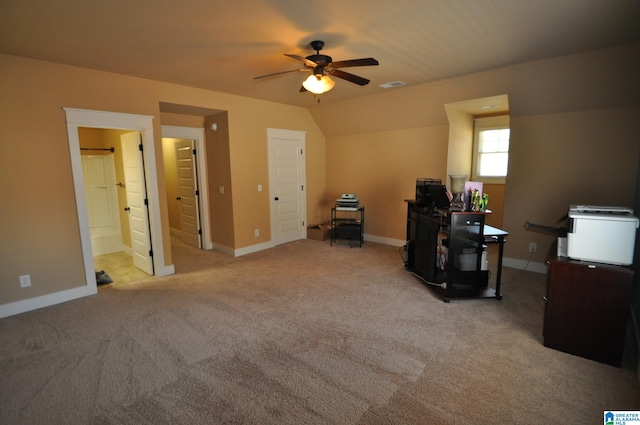 carpeted office space featuring lofted ceiling and ceiling fan