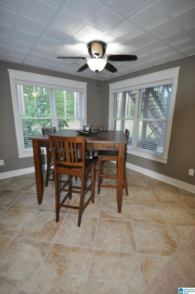 dining area with ceiling fan and light tile floors