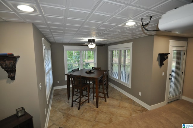 dining space with tile flooring and ceiling fan