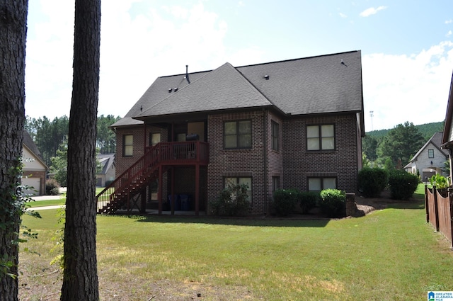 rear view of property with a yard