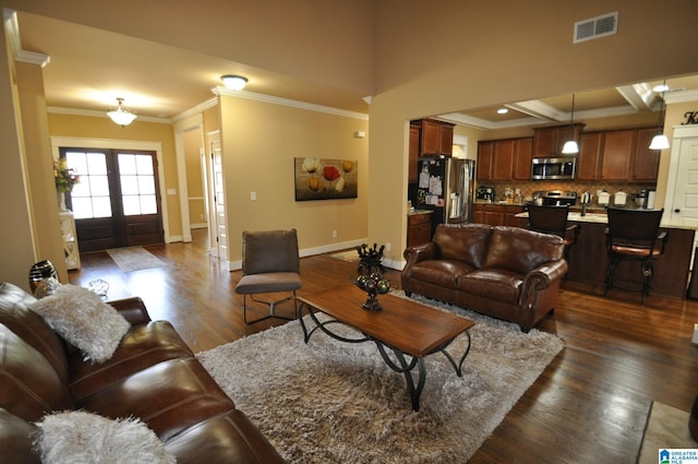 living room featuring hardwood / wood-style floors, ornamental molding, and french doors