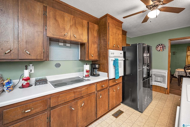 kitchen featuring a textured ceiling, white appliances, ceiling fan, and light tile floors