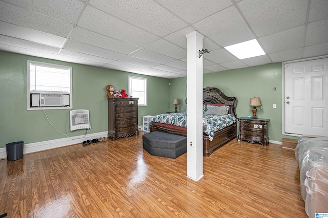 bedroom featuring hardwood / wood-style flooring and a paneled ceiling