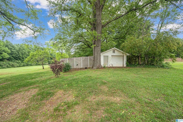 view of yard with a garage and an outdoor structure