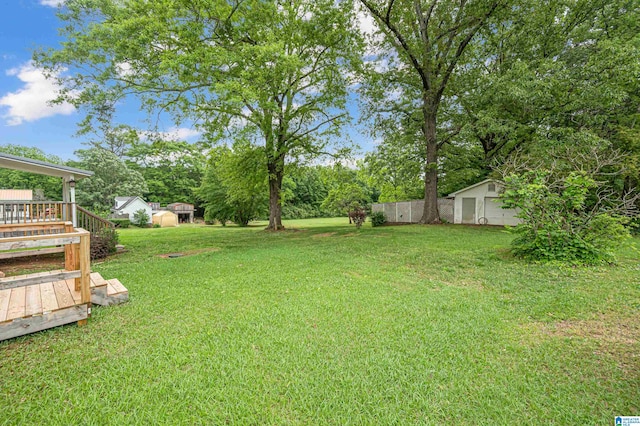 view of yard with a deck and a shed