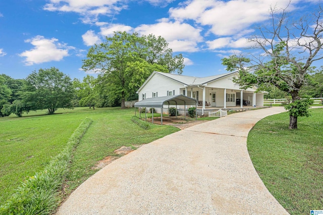 view of front of home with a front yard, a carport, and covered porch