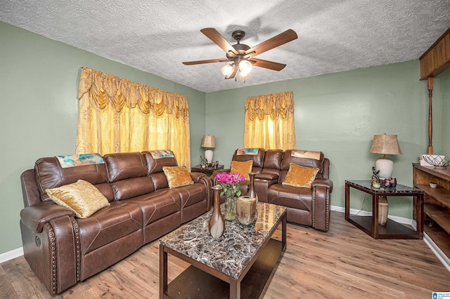 living room featuring a textured ceiling, hardwood / wood-style floors, and ceiling fan