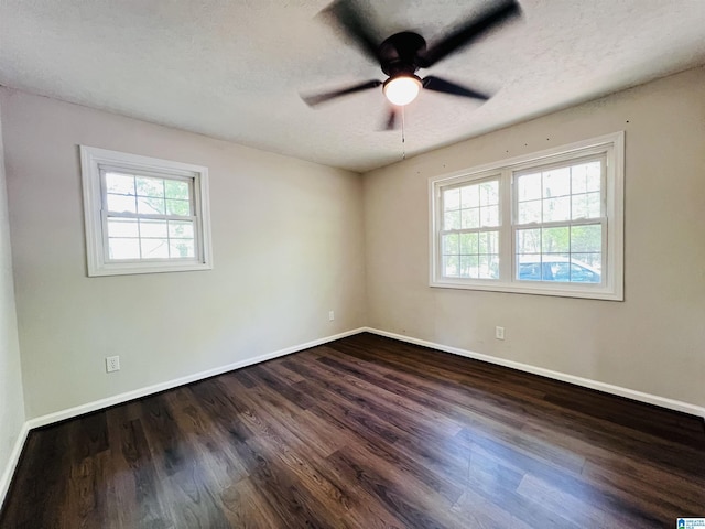 unfurnished room featuring ceiling fan, baseboards, dark wood-style flooring, and a textured ceiling