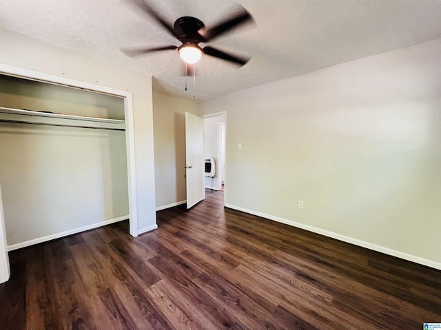 unfurnished bedroom with dark wood finished floors, baseboards, a ceiling fan, and a closet