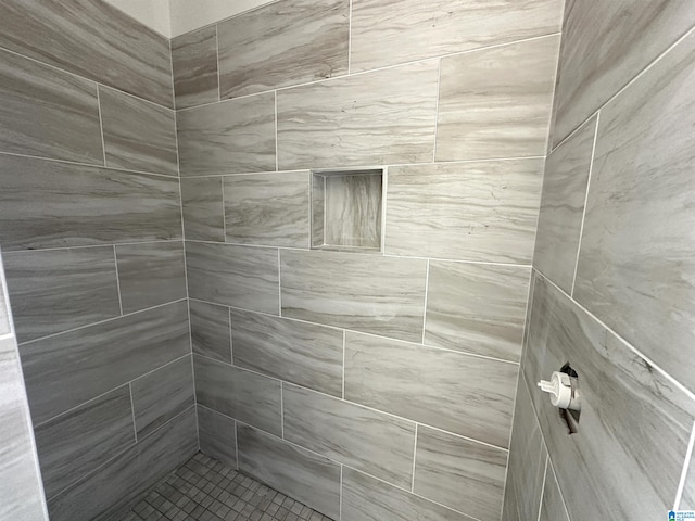 bathroom with a tile shower