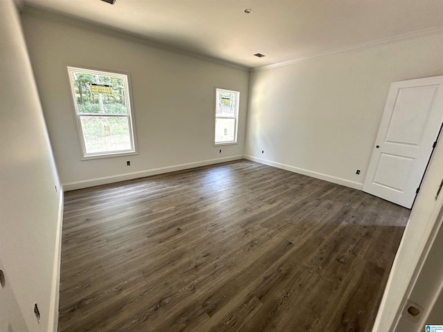 empty room with ornamental molding and dark hardwood / wood-style flooring