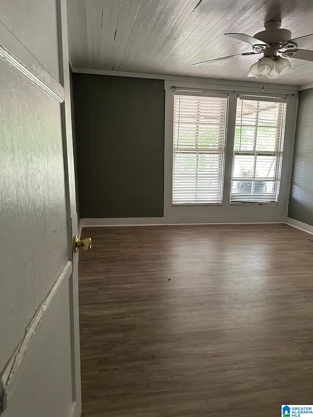 empty room with wooden ceiling, ceiling fan, and dark wood-type flooring