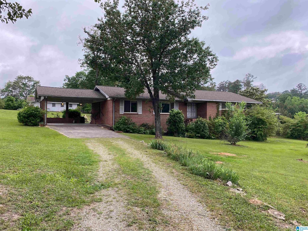 ranch-style house with a front yard and a carport