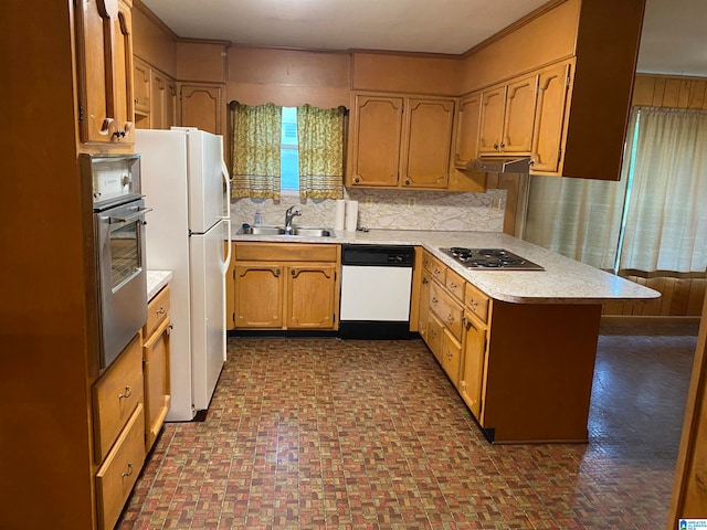 kitchen with white appliances, backsplash, crown molding, and sink