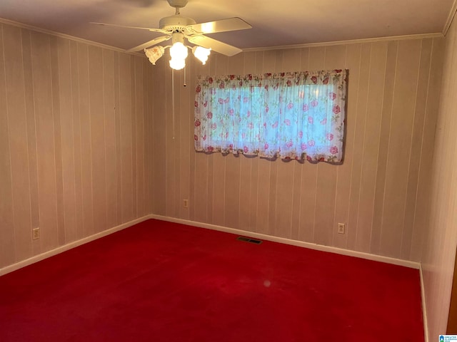 spare room with carpet, ceiling fan, and ornamental molding