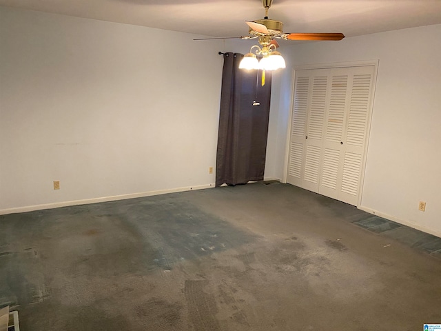 unfurnished bedroom featuring ceiling fan, a closet, and dark carpet