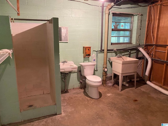 bathroom featuring toilet, concrete floors, and walk in shower