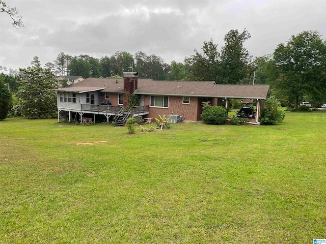 back of house with central AC unit, a wooden deck, and a lawn