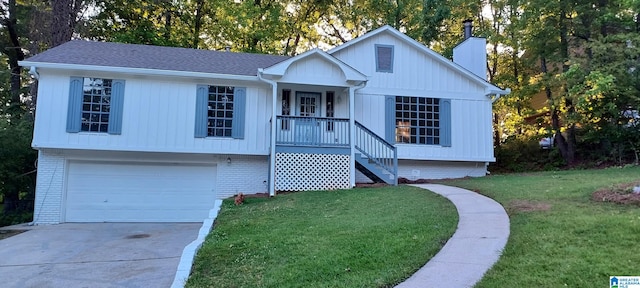 view of front of house with a garage and a front lawn