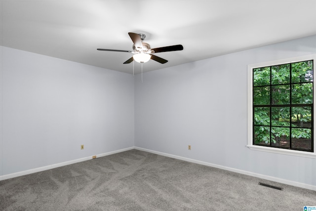 carpeted empty room featuring ceiling fan