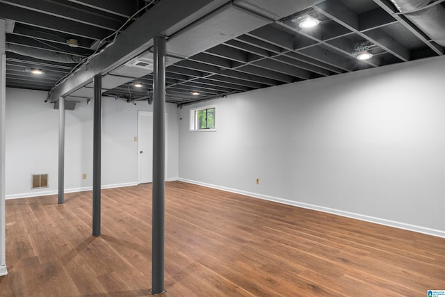 basement with hardwood / wood-style floors