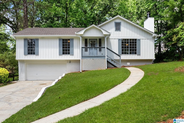 view of front of property with a front yard, a porch, and a garage