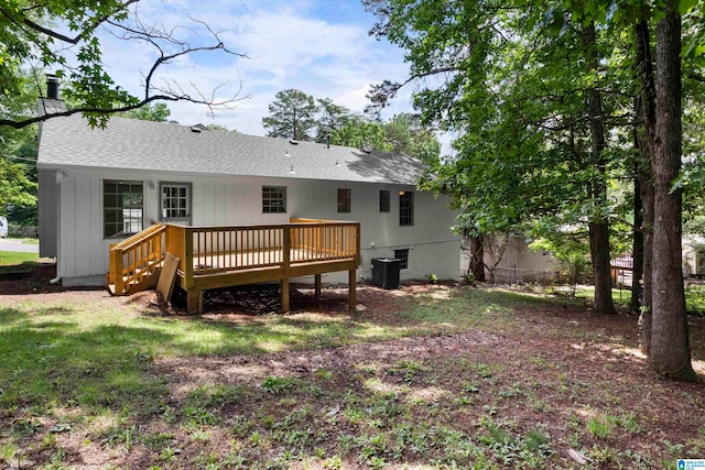 rear view of property with central AC unit and a wooden deck