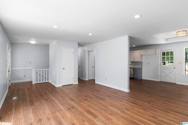 unfurnished living room with dark wood-type flooring