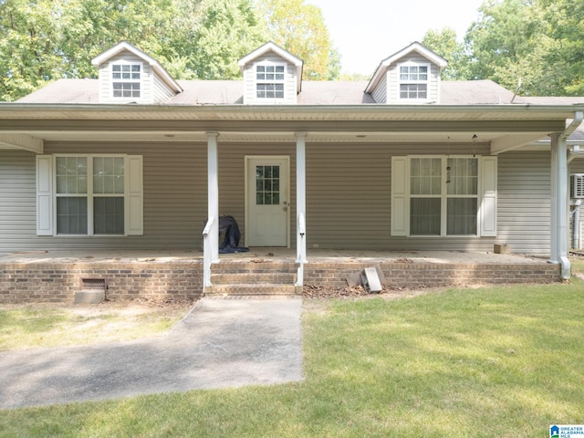 view of front of house featuring covered porch and a front lawn