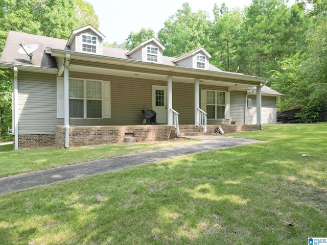 cape cod home featuring a porch and a front yard